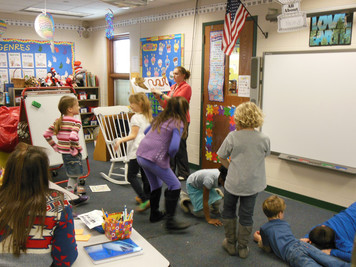 Reading & MOVING with our wonderful PE teacher!